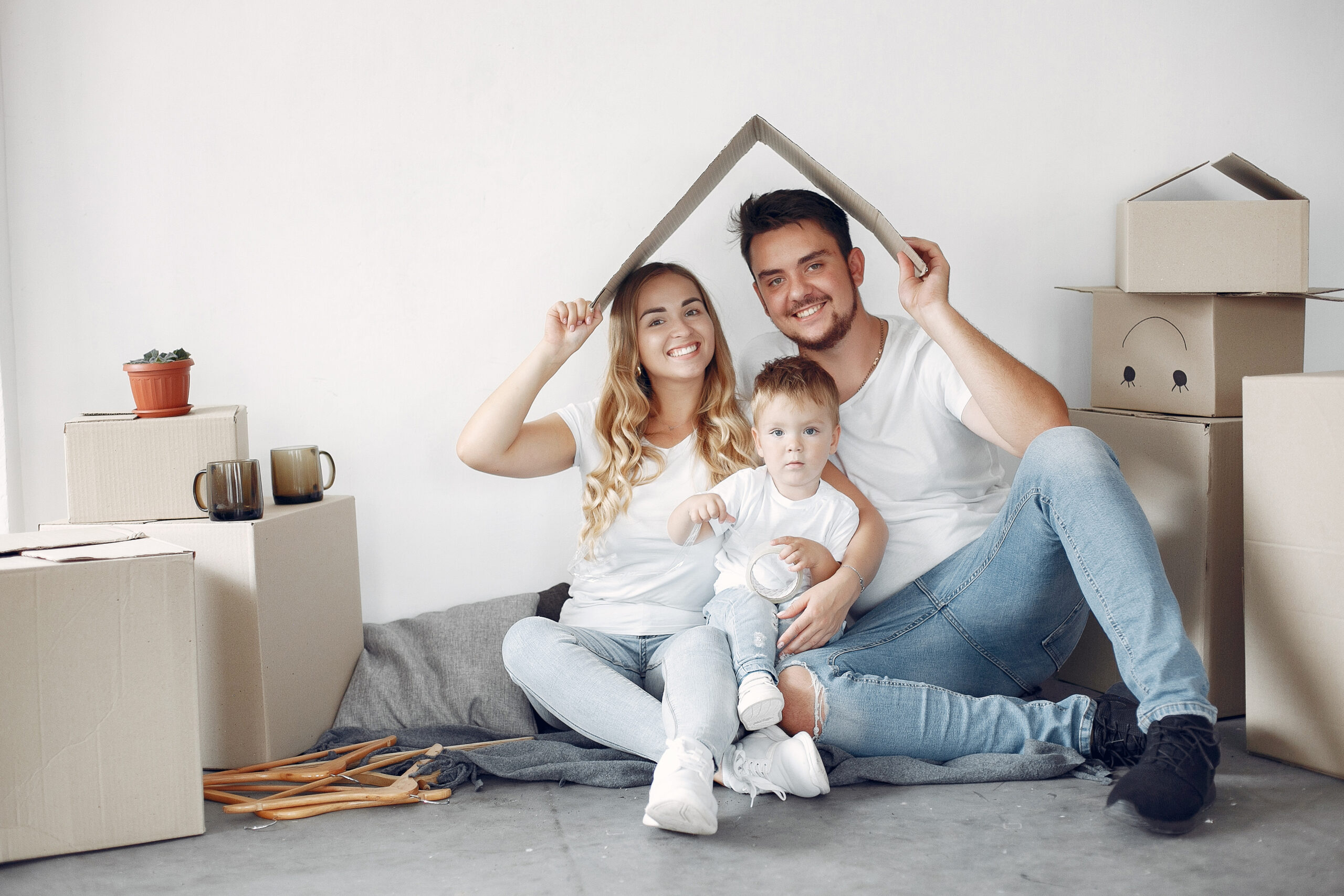 Family moving. People use a boxes. Little boy with parents.